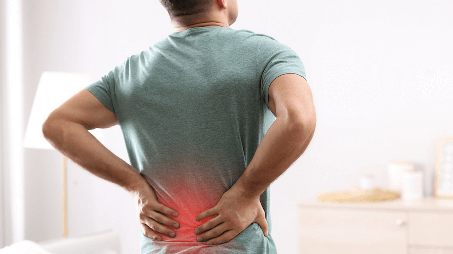 A man holding his back in pain due to stress